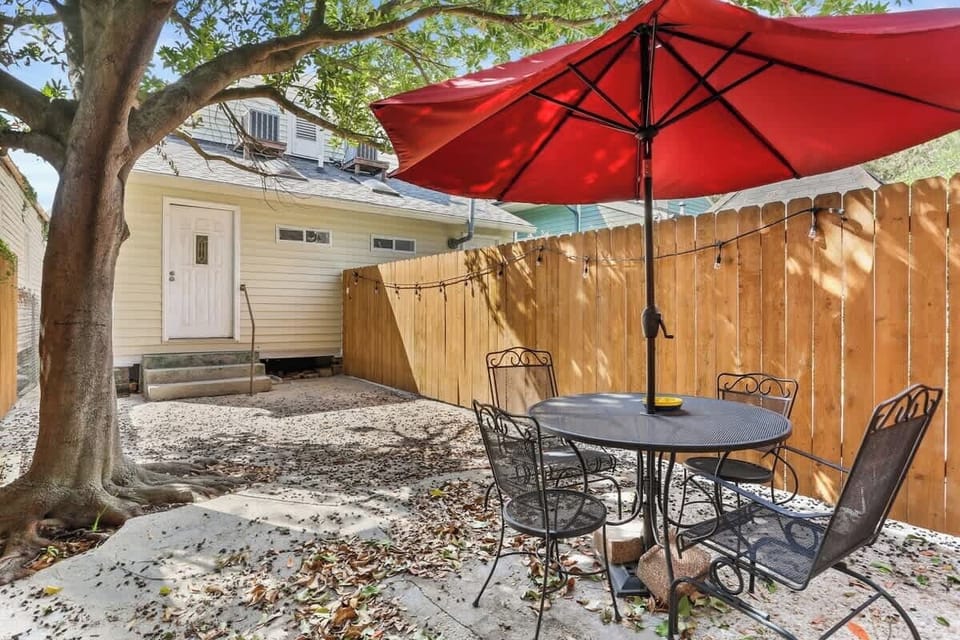 Private outdoor patio with seating and umbrella—great for morning coffee or evening conversations.