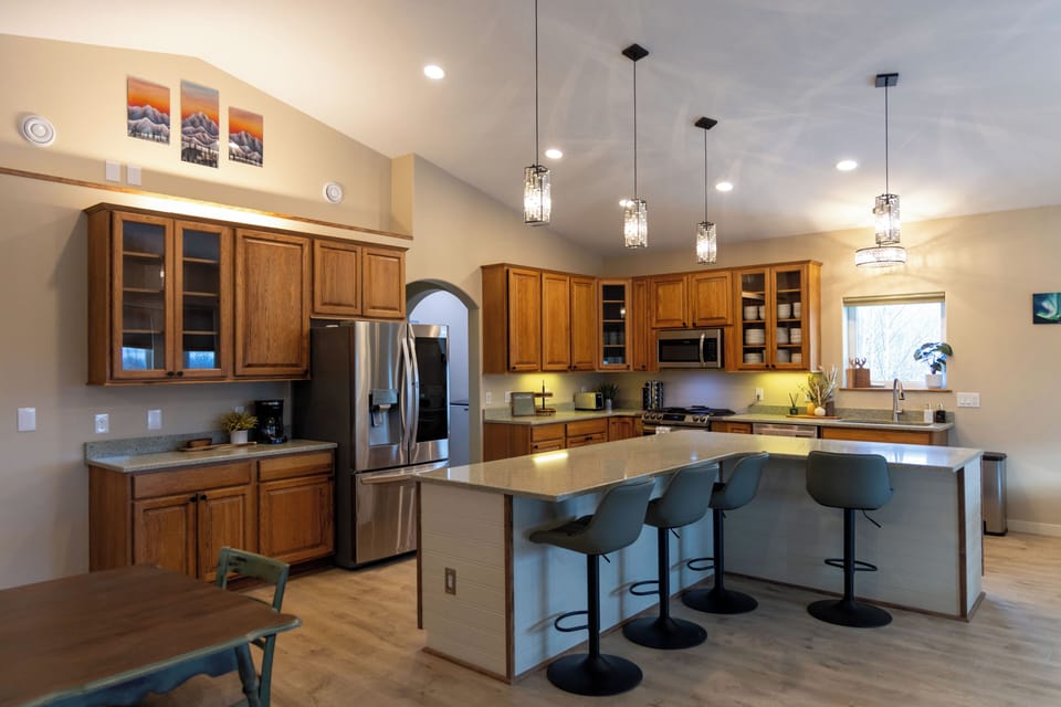 Kitchen offers vaulted ceilings, and large island with seating for four