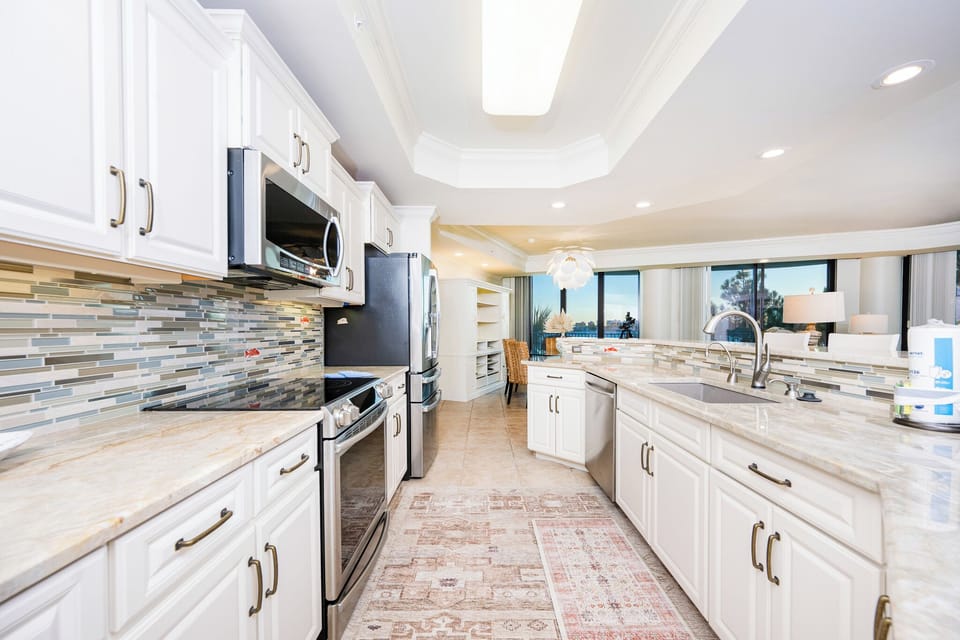 Upgrade your culinary experience in this stylish kitchen with modern stainless appliances and elegant design