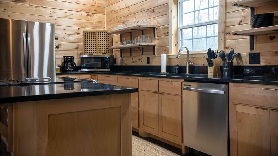 Fully stocked kitchen with stainless appliances and open shelving