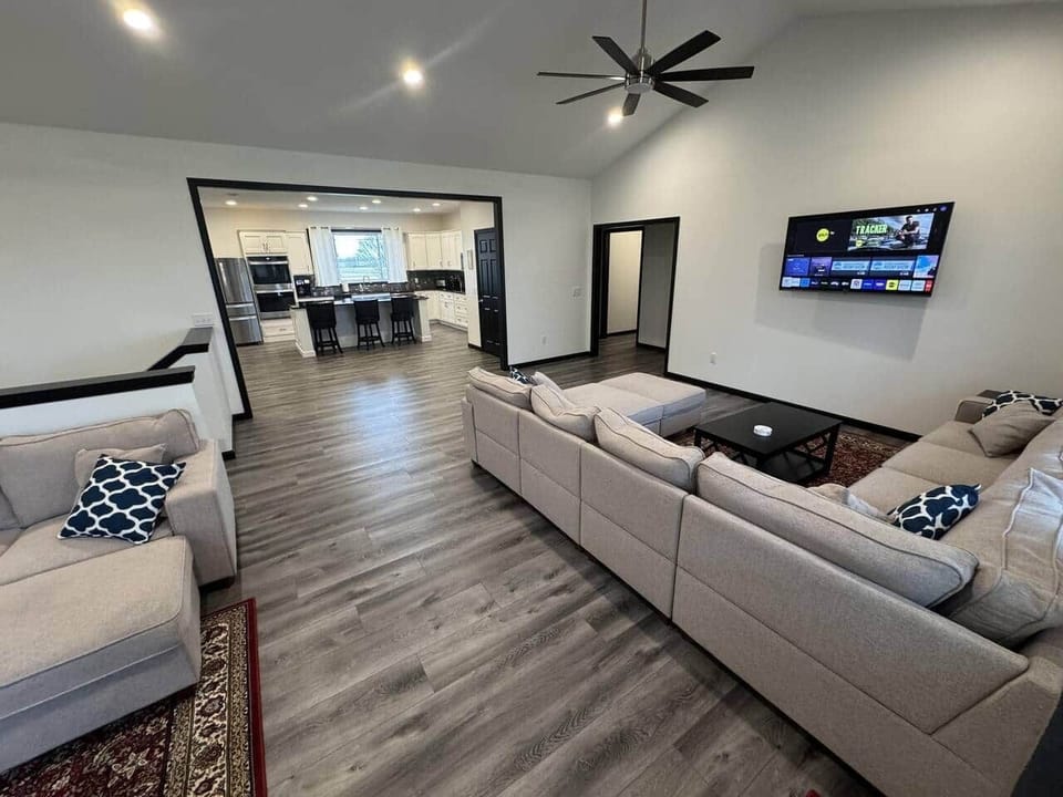 A view from the living room into the full kitchen shows the space's openness.