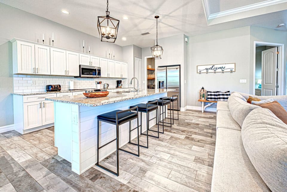 Kitchen with stainless appliances, large granite island  that seats 4 with sink in the island