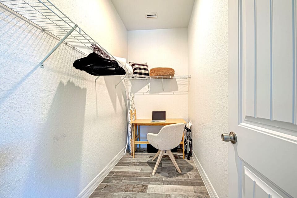 Closet in the primary bedroom also set up as an office