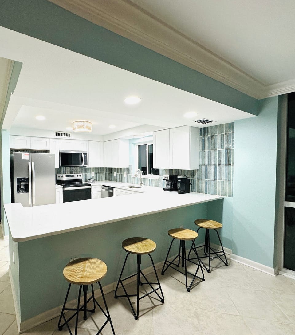 Four adjustable barstools at the counter.