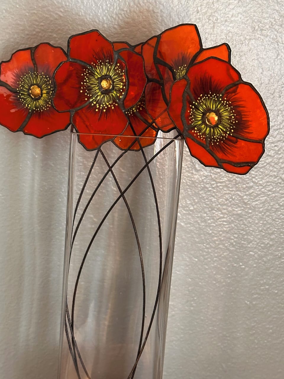 Beautiful stained glass flowers on TV mantel