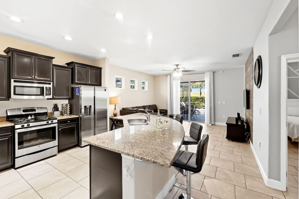 Kitchen to living room to sliders that lead to pool.