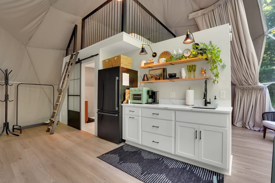 The kitchenette is equipped with essentials like a refrigerator, sink, air fryer/toaster oven, and Keurig coffee maker.
