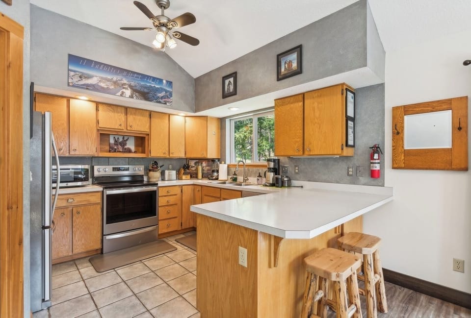 A warm and inviting kitchen with natural wood finishes and modern appliances. | Upper Level