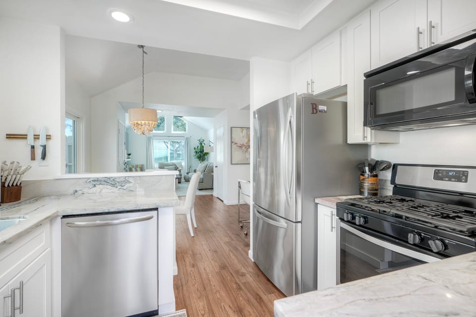 Open kitchen flows into bright dining area