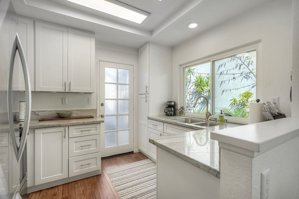 Modern kitchen with marble counters and skylight