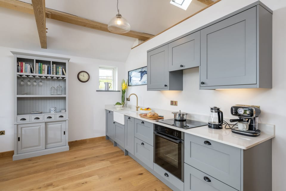The kitchen area with dresser for extra storage