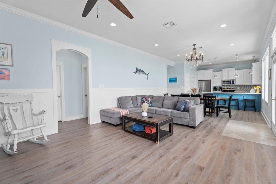 Modern open layout with cozy seating, hardwood floors, and easy access to kitchen—perfect for family gatherings.