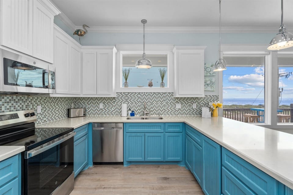 Open dining space with a large table for group meals, connected to a fully equipped kitchen—ideal for family-friendly vacation stays in Crystal Beach TX.