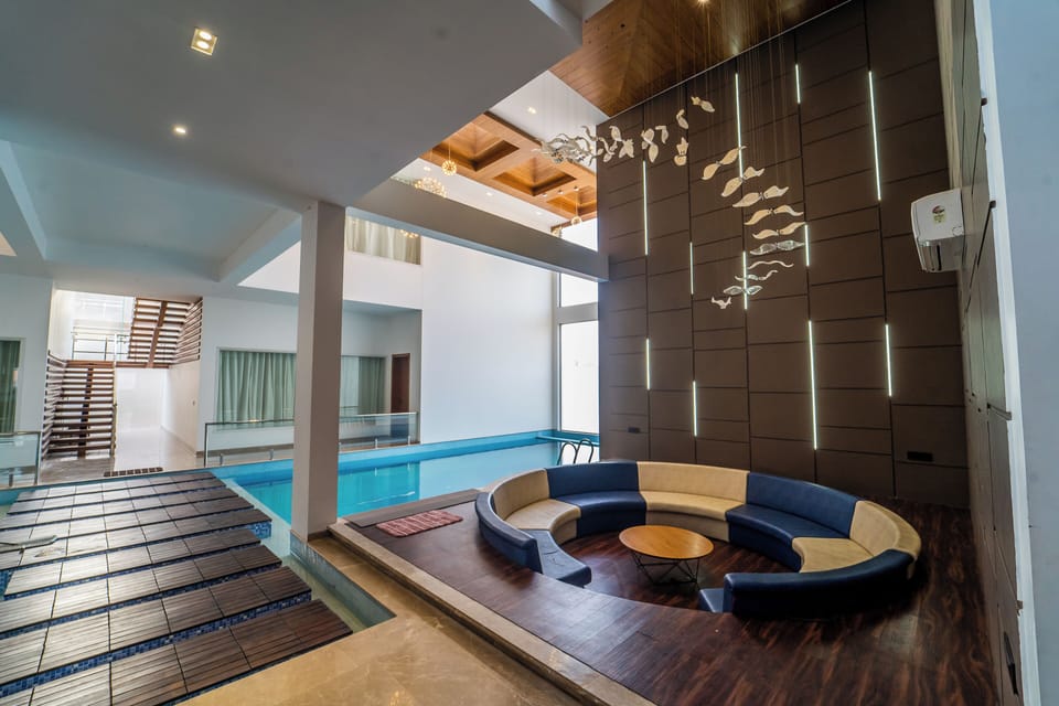 Mangalam Villa | Living area | 55-inch flat-screen TV with satellite channels