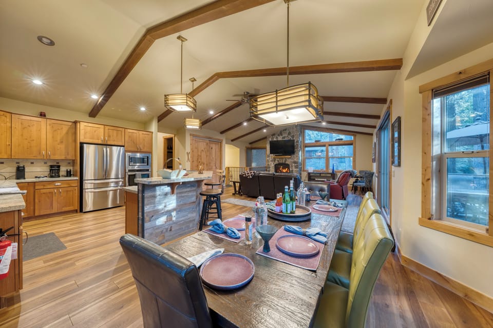 Kitchen and dining area with high ceilings and warm wood tones.