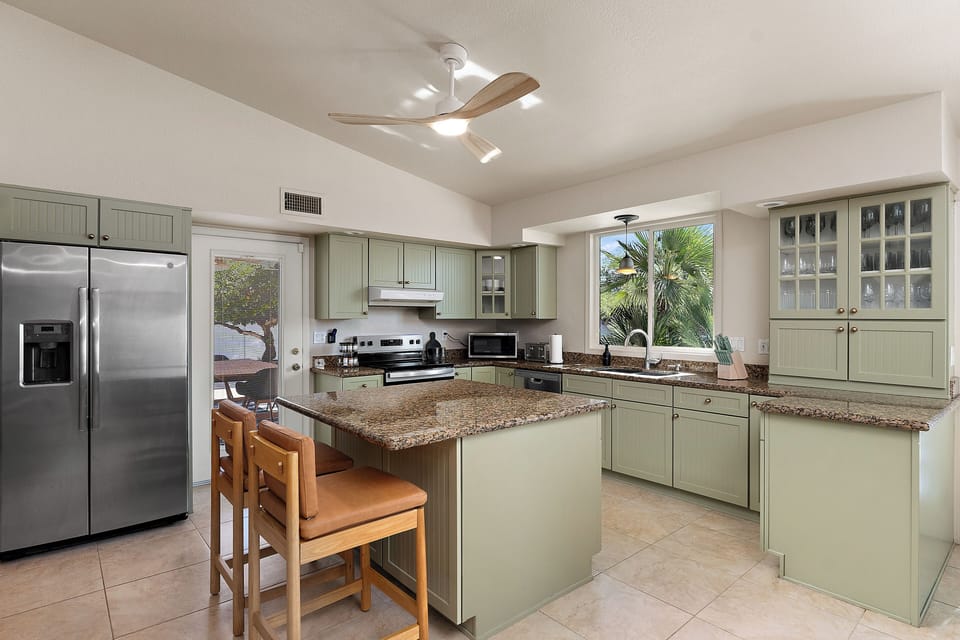 Fully equipped kitchen with new appliances and a spacious island for two.