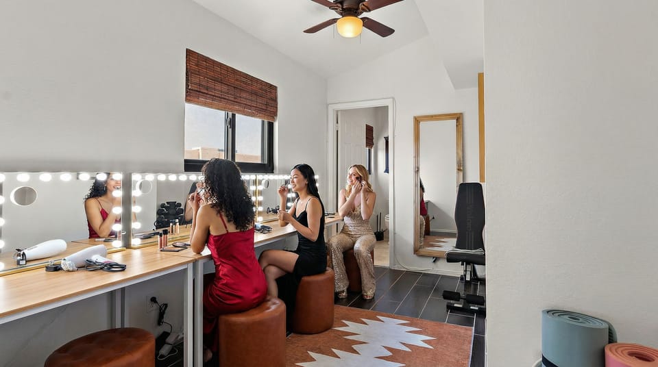 Glam room with lighted vanity mirrors for getting ready