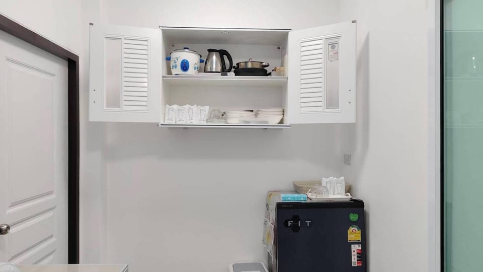Fridge, electric kettle, cleaning supplies, paper towels