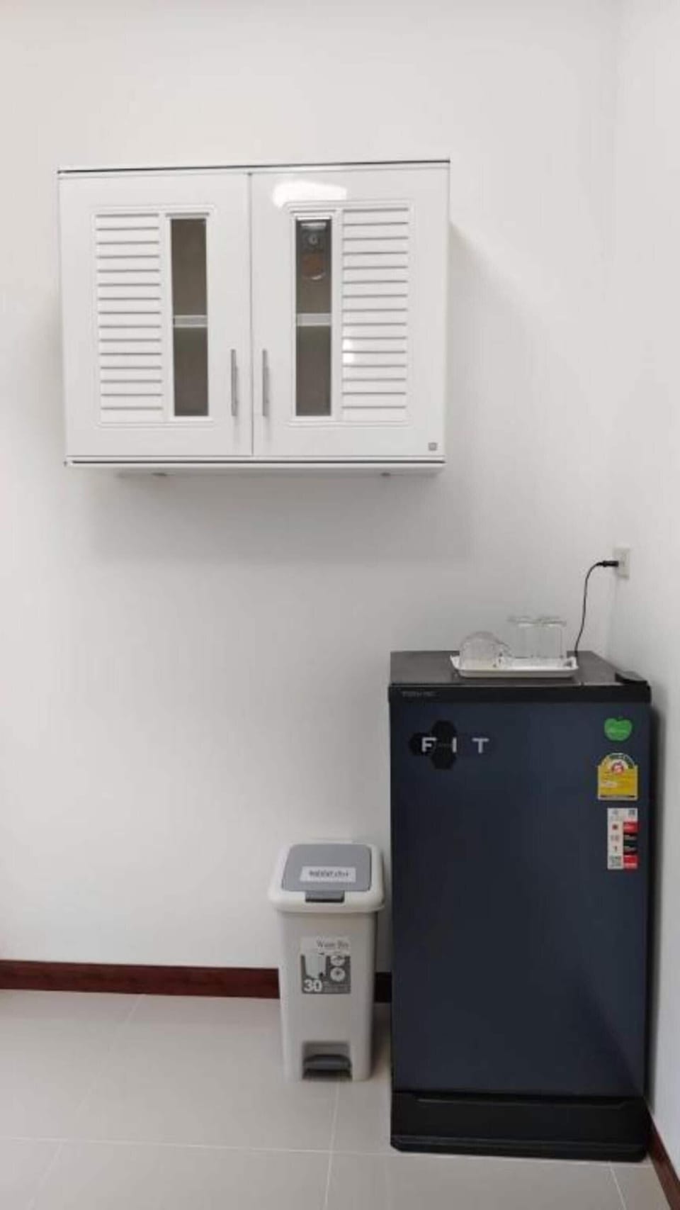 Fridge, electric kettle, cleaning supplies, paper towels