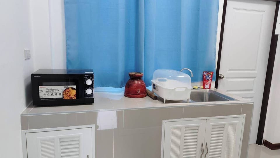 Fridge, electric kettle, cleaning supplies, paper towels