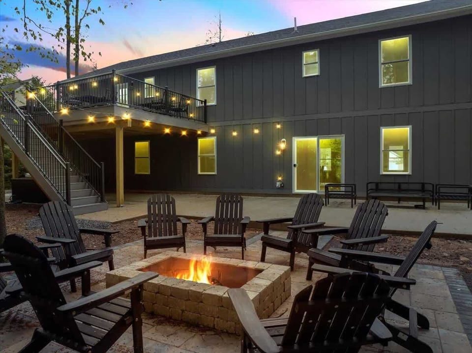 Outdoor Fire Pit Lounge with String Lights & Seating Area