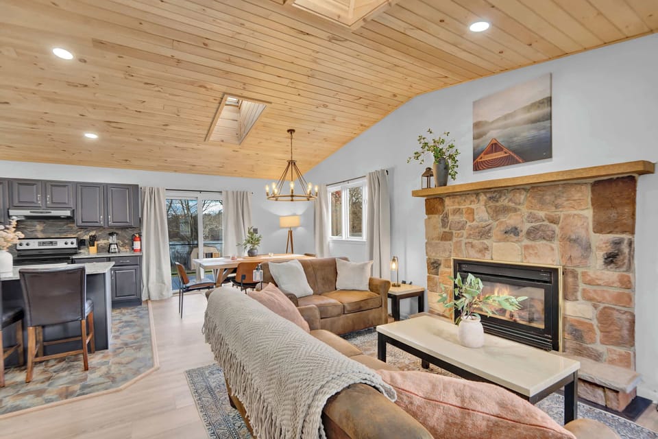 Open Concept Living Room with Fireplace and Wood Ceiling