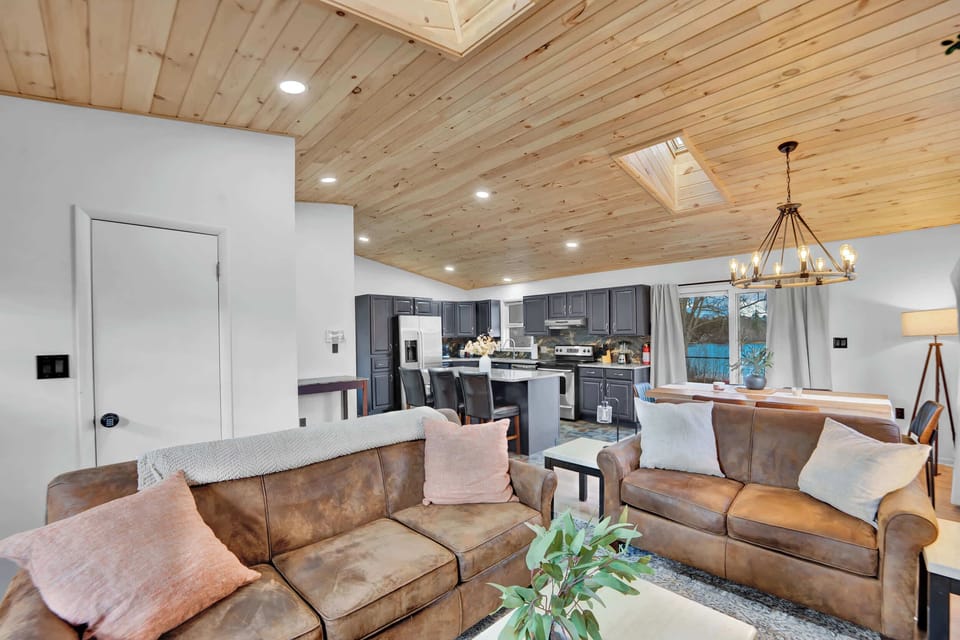 Bright Living Room with Vaulted Wood Ceiling