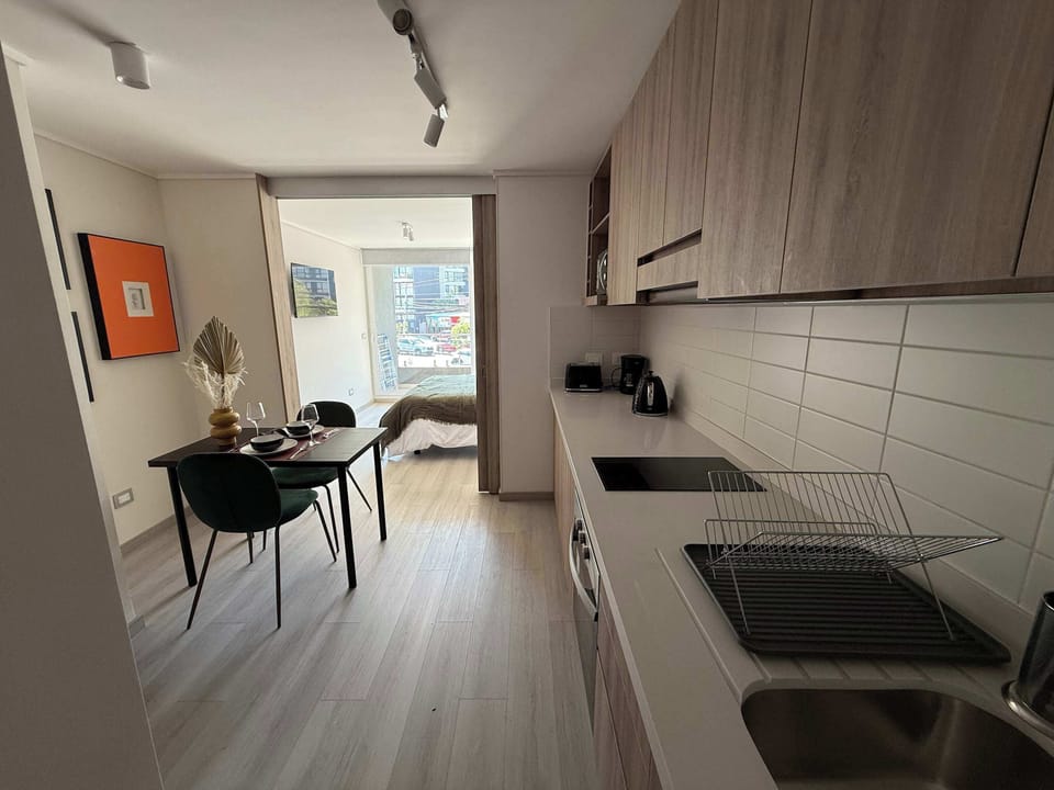Cozy studio kitchen with modern amenities and a stylish dining area, perfect for a comfortable stay.