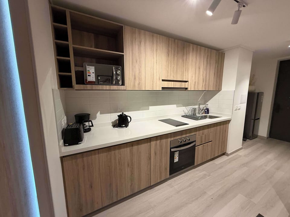 Modern kitchen with sleek appliances and ample storage, perfect for cooking your favorite meals.
