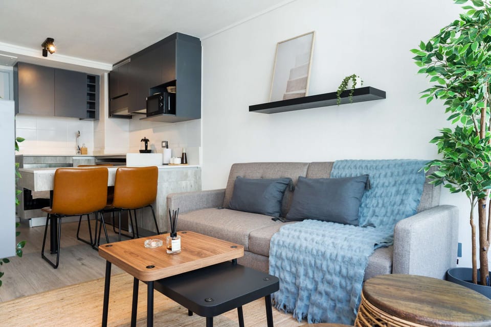 Cozy and modern living space with a stylish kitchen and dining area, perfect for a relaxing stay.