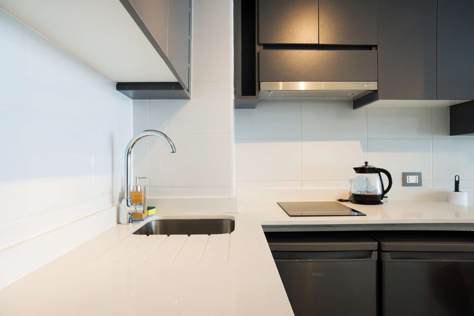 Experience a sleek, modern kitchen with all essentials for your culinary needs in this cozy studio apartment.