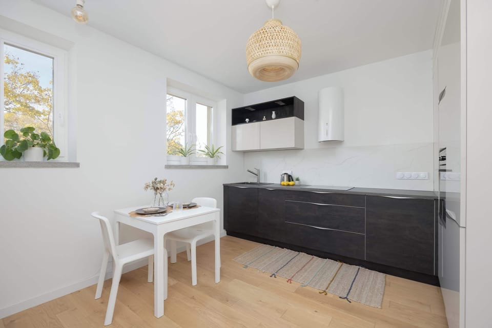 The bright kitchen with a modern dining area creates a pleasant space where breakfast tastes even better in natural light.