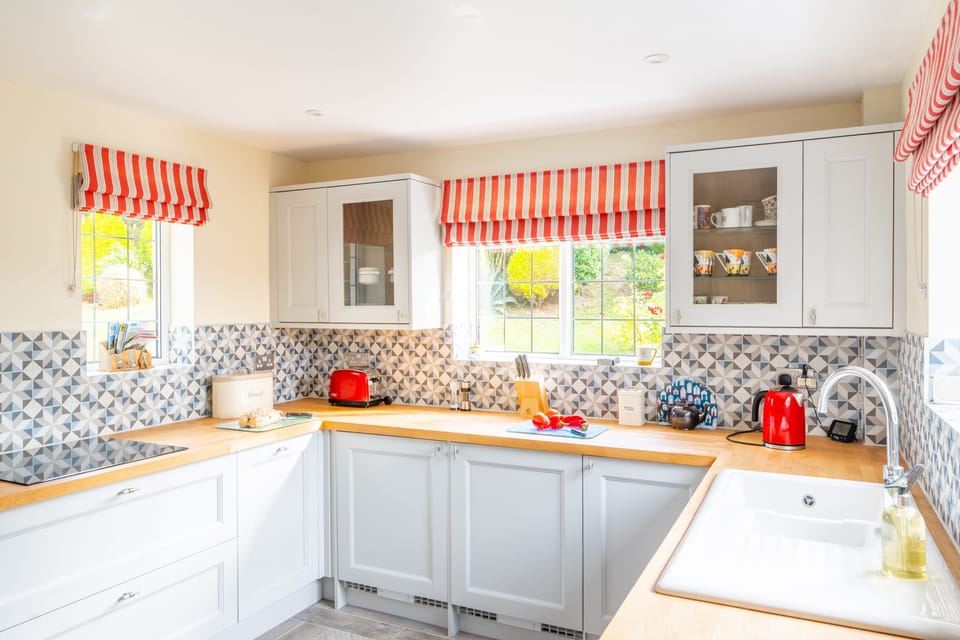 Ground floor: Kitchen with an electric oven and induction hob, microwave, dishwasher, fridge-freezer and washing machine