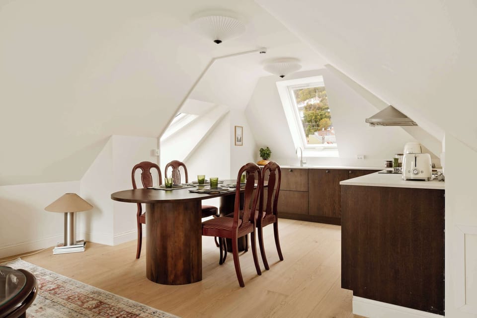 Gather beneath skylights in this open dining area—perfect for shared breakfasts or cozy dinners at home.