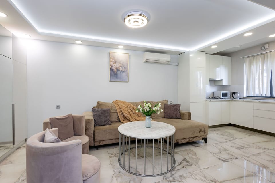 Apartment, 1 Bedroom | Living area | 50-inch flat-screen TV with cable channels