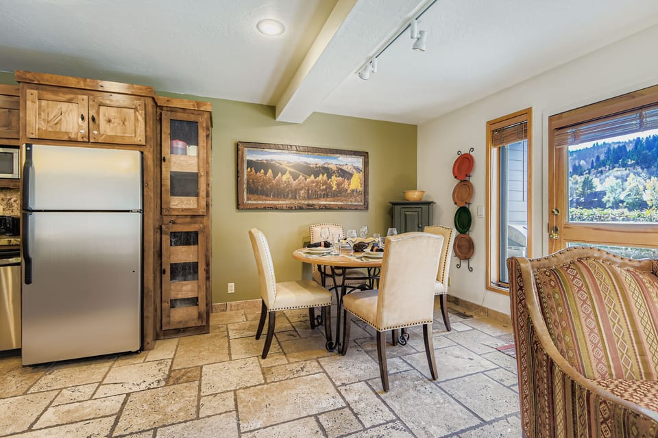 Enjoy meals in the charming breakfast nook with rustic cabinetry and ample seating. It's a cozy spot to start your day in Park City.