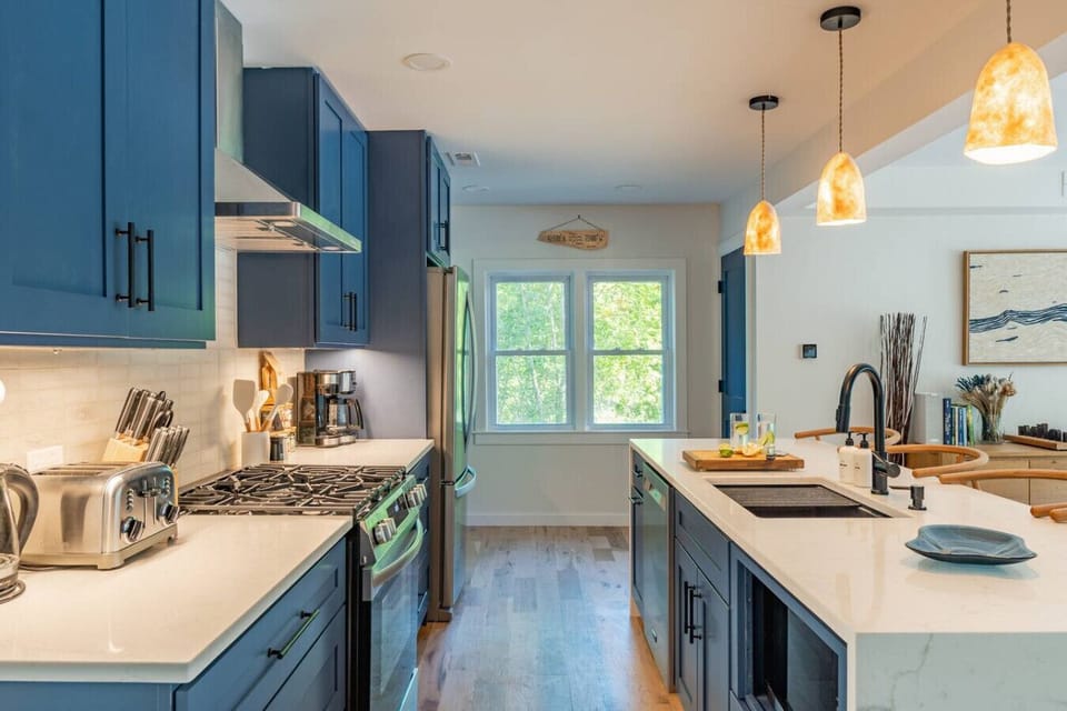 Spacious open kitchen with Quartz counters and stainless appliances.