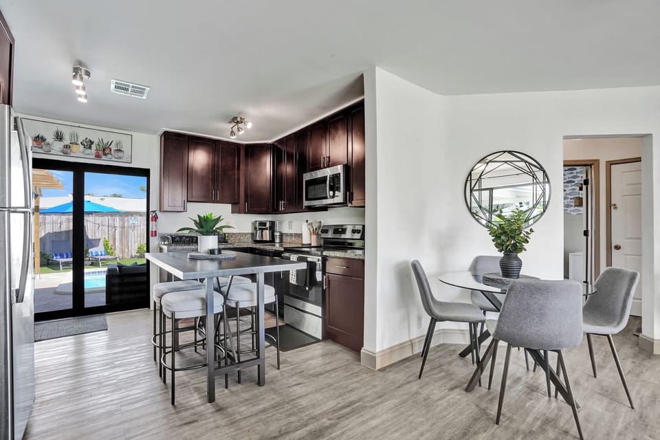 Bright kitchen with island and dining for four—open and inviting.
