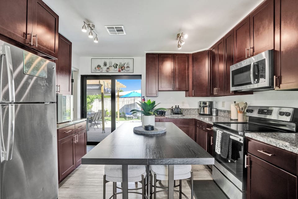 Spacious kitchen with island, fully equipped for shared meals and gatherings.
