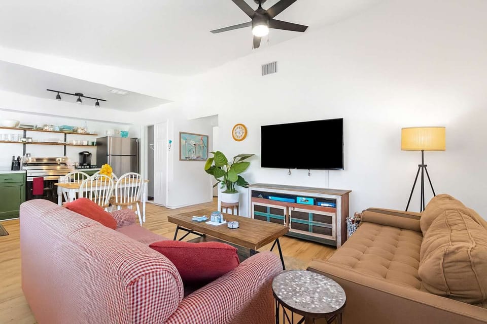 Spacious living area with plush sofa bed & Roku TV for cozy movie nights. Sun-drenched space with hardwood floors creates the perfect spot to unwind, catch up on shows, or accommodate extra guests in comfort.