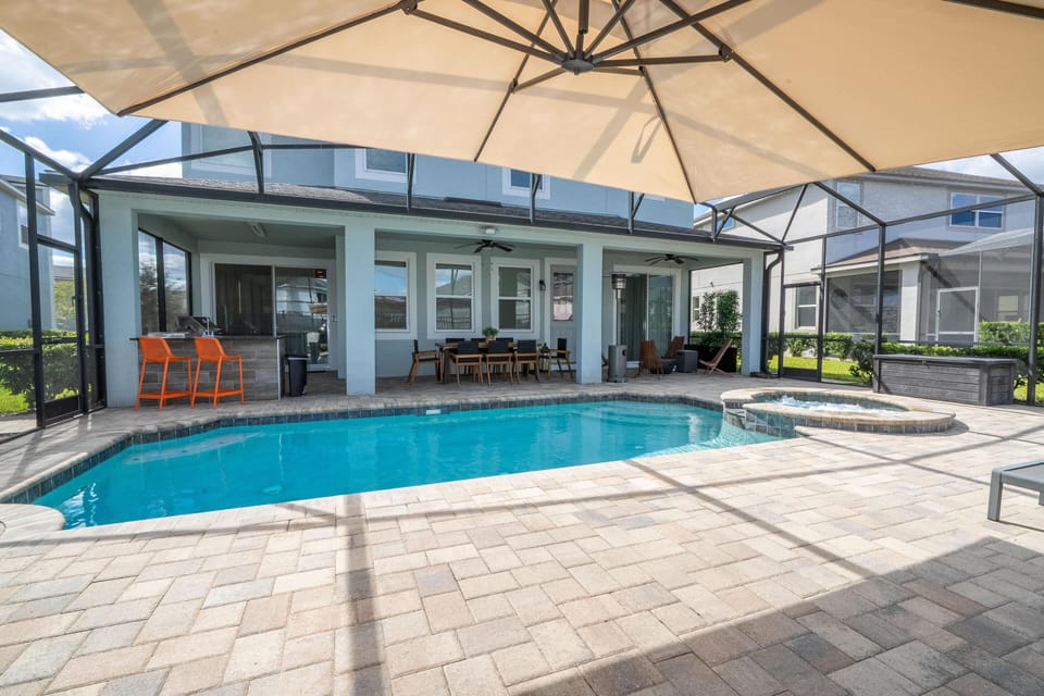 Sunlit poolside patio with spacious seating and shade