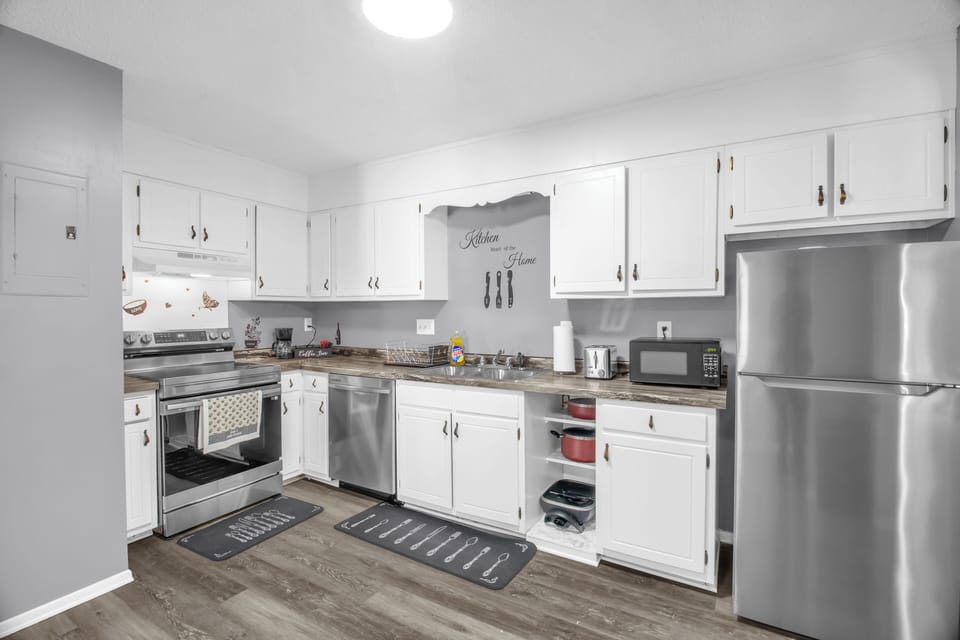 Fully equipped kitchen with cookware, appliances, and cooking basics.