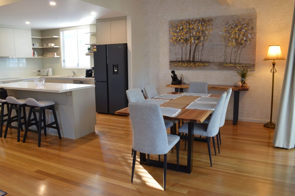 Cross section view of dining table, kitchen, living room