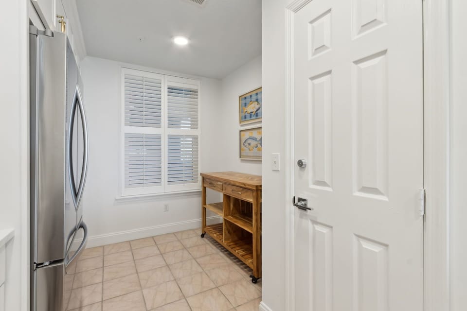 Luxury Completely Remodeled Kitchen with Stainless Steel Appliances, Stunning White Cabinetry, Quartz Countertops, a Shiplapped Island, and a Trendy Backsplash