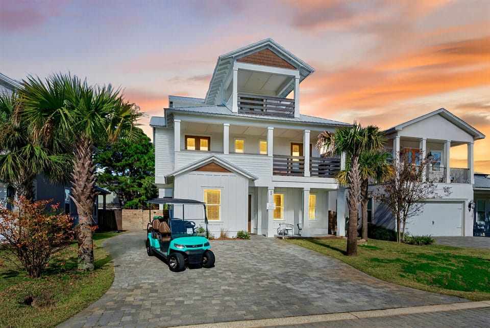 Vibe Out – sleeps 24! Steps from private gated beach access with a FREE golf cart. Relax in your backyard oasis with a HEATED pool, lounge chairs, outdoor dining, and a putt putt green —perfec