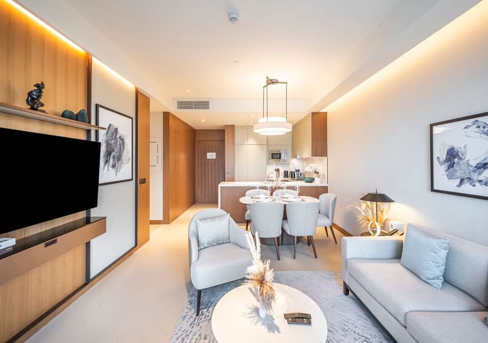 Bright living, dining, and kitchen space with Burj Khalifa views.