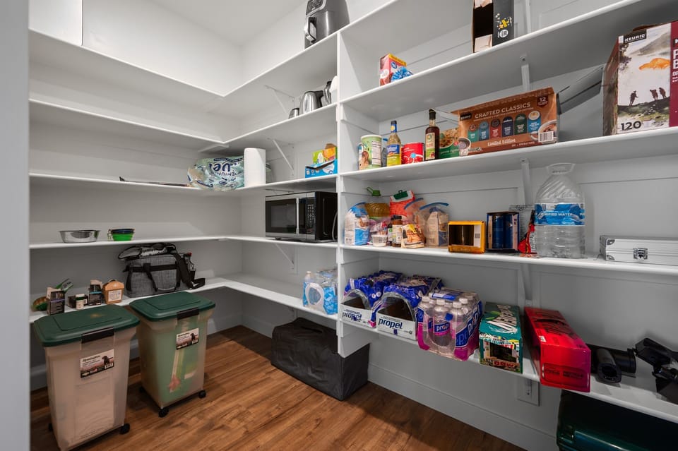 Fully stocked walk-in pantry with organized shelving and all the essentials for extended stays.