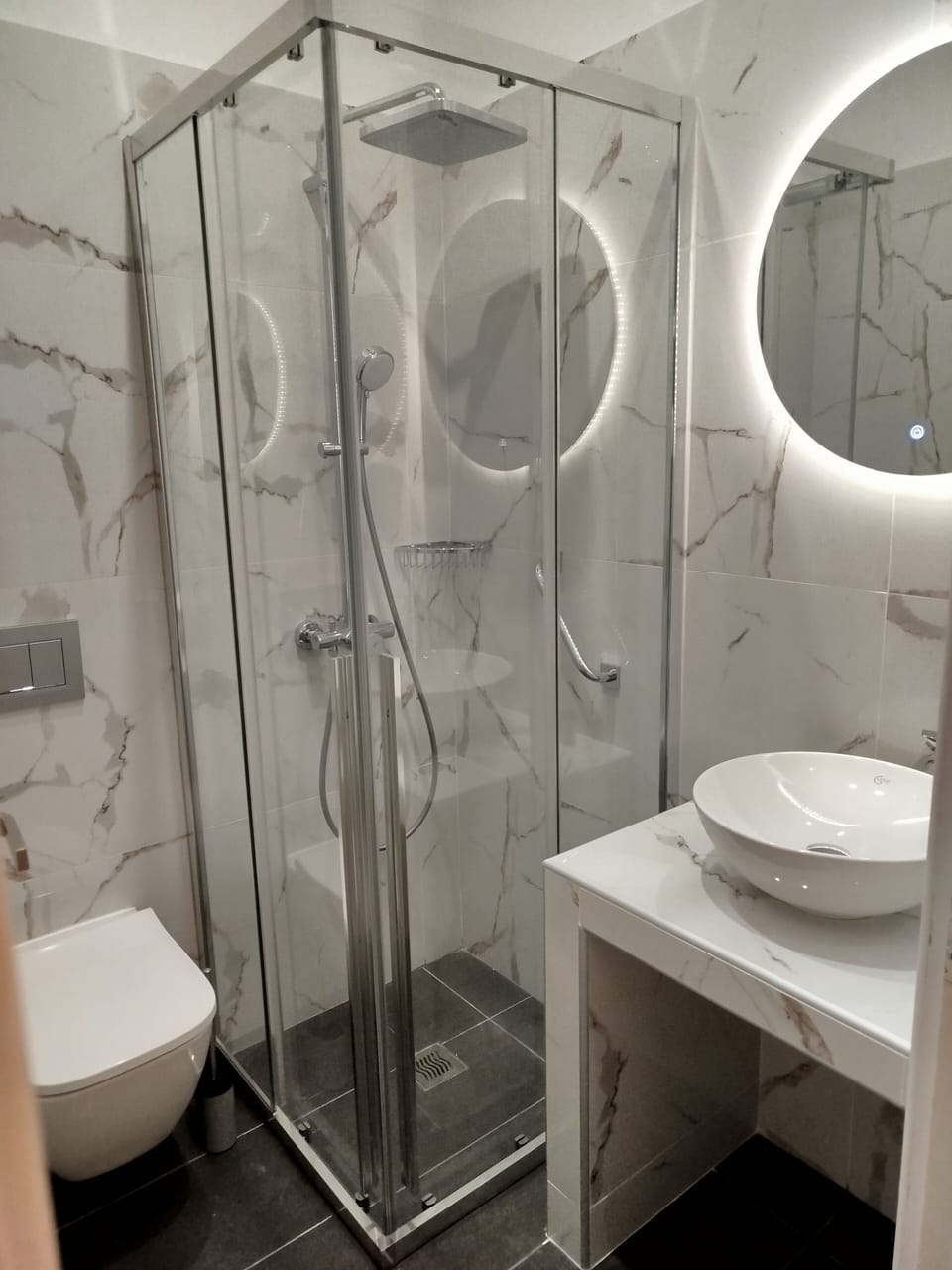 Shower, rainfall showerhead, hair dryer, towels