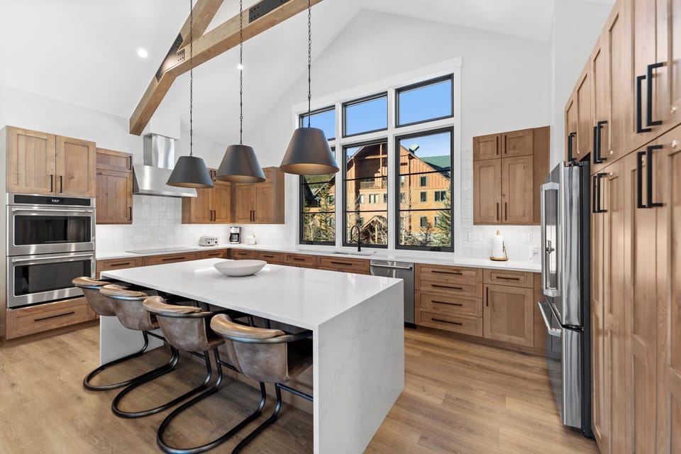 Your spacious kitchen features warm wood cabinets, marble countertops, and modern appliances perfect for preparing memorable meals together.