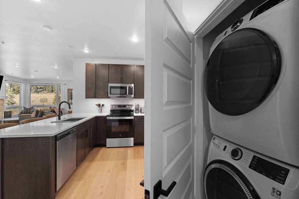 Your modern kitchen features sleek appliances and flows seamlessly into bright living spaces, while convenient laundry facilities keep your stay comfortable.